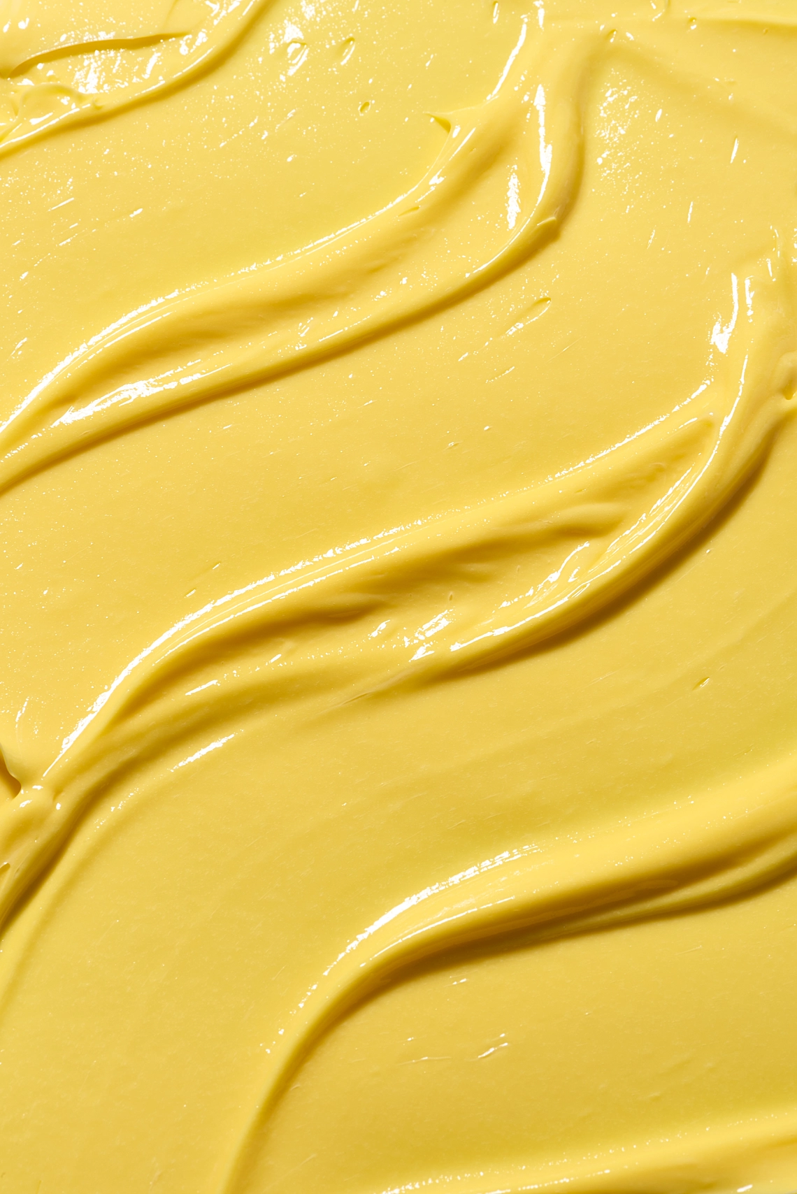Photographie de texture d'une crème pour le corps de couleur jaune orange - Photographe cosmetiques - photographe texture cosmetiques - photographe produits cosmetiques - Aurore Aivrest