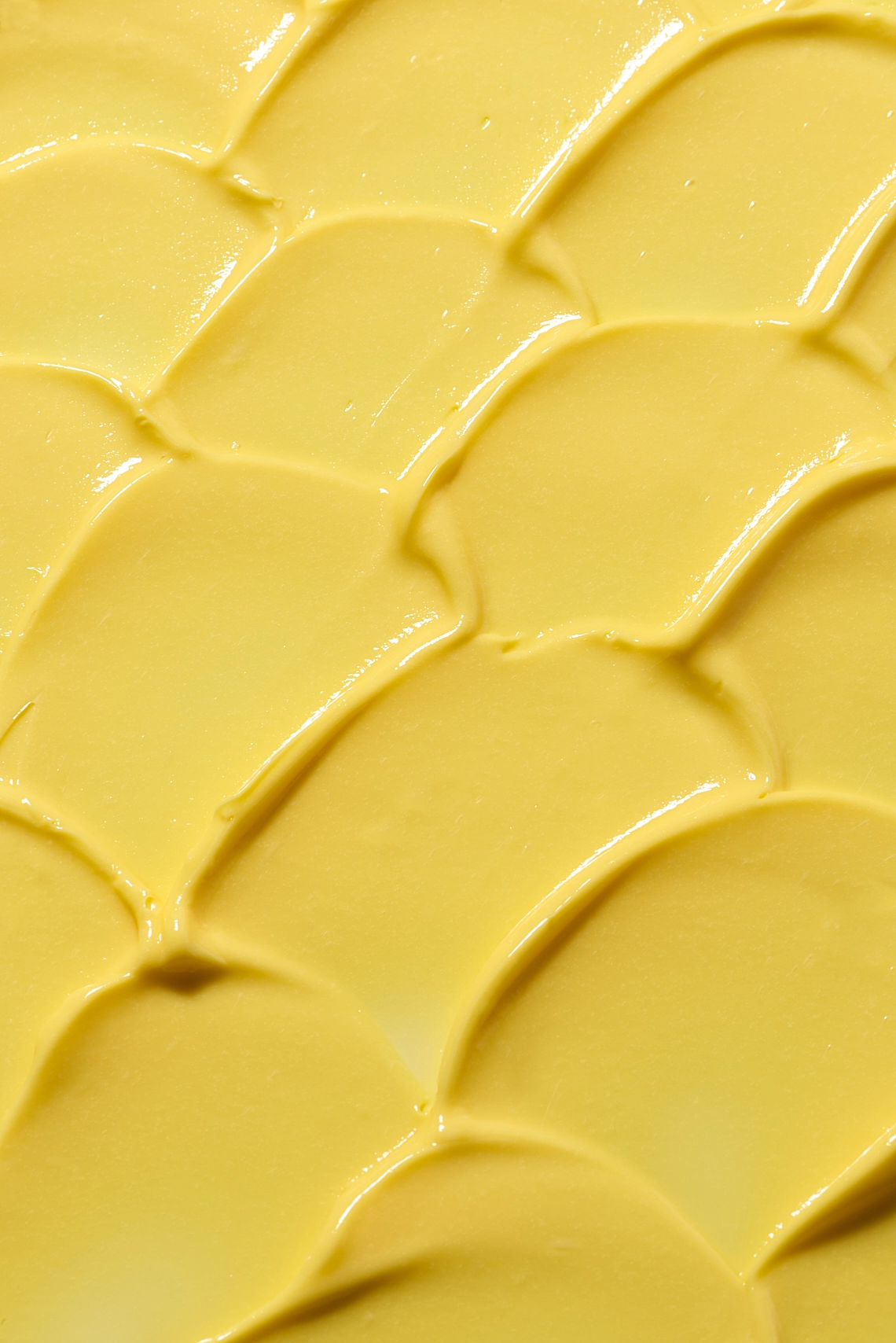 Photographie de texture d'une crème pour le corps de couleur jaune orange - Photographe cosmetiques - photographe texture cosmetiques - photographe produits cosmetiques - Aurore Aivrest